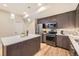 Well-lit kitchen with stainless steel appliances, an island, and ample cabinet space at 2442 S Bannock St, Denver, CO 80223