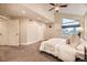 Bedroom with a large window, ceiling fan, and neutral-toned walls at 2442 S Bannock St, Denver, CO 80223