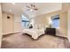 Spacious bedroom with vaulted ceiling, plush carpet, and natural light at 2442 S Bannock St, Denver, CO 80223