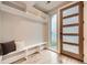 Mudroom boasts wood-look tile floors, built in shelves, and a wood door with frosted glass windows at 2442 S Bannock St, Denver, CO 80223
