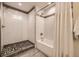 Modern bathroom with subway tile shower, built-in bench, and glass doors at 2442 S Bannock St, Denver, CO 80223