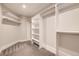 Walk-in closet with shelving, closet rods, and carpeted floors at 2442 S Bannock St, Denver, CO 80223