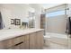 Modern bathroom featuring a sleek vanity with stone countertop, a bathtub with shower and neutral gray tiling at 3414 W 18Th Ave, Denver, CO 80204