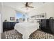 Bright bedroom featuring a ceiling fan, neutral walls, and a large window with city views at 3414 W 18Th Ave, Denver, CO 80204