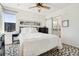 Well-lit bedroom with ceiling fan, white walls, and a decorative animal print carpet at 3414 W 18Th Ave, Denver, CO 80204