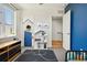 bedroom with blue accent wall, creative door design, and playful decor at 3414 W 18Th Ave, Denver, CO 80204