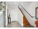 Warm and inviting entryway with tile floors and a wooden staircase at 3414 W 18Th Ave, Denver, CO 80204