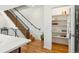 Hallway with hardwood floors, staircase with metal railing, and a pantry at 3414 W 18Th Ave, Denver, CO 80204