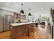 Bright, open kitchen with stainless steel appliances, a large island, and modern pendant lighting at 3414 W 18Th Ave, Denver, CO 80204