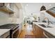 Modern kitchen with stainless steel appliances, island, and an open floorplan to the living area at 3414 W 18Th Ave, Denver, CO 80204