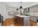 Bright modern kitchen with stainless steel appliances, island with breakfast bar, and hardwood floors at 3414 W 18Th Ave, Denver, CO 80204