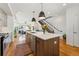 Bright open concept kitchen with island, hard wood flooring, and a modern staircase at 3414 W 18Th Ave, Denver, CO 80204
