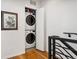 Stacked washer and dryer in an alcove with hardwood floors at 3414 W 18Th Ave, Denver, CO 80204