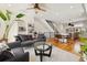 Open-concept living room with a comfortable sofa, hardwood floors, and modern fixtures at 3414 W 18Th Ave, Denver, CO 80204