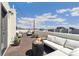 Inviting rooftop deck with comfortable seating, fire pit, string lights and cityscape views, perfect for relaxing at 3414 W 18Th Ave, Denver, CO 80204