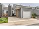 Charming home featuring gray siding, a one-car garage, brick accents, and a well-maintained front yard at 3798 E 118Th Way, Thornton, CO 80233