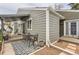A cozy patio area features a table, seating, stylish rug, and a hanging chair under a covered section, perfect for outdoor relaxation at 3798 E 118Th Way, Thornton, CO 80233