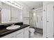 Bathroom with shower stall and updated vanity at 3184 S Heather Gardens Way # 403, Aurora, CO 80014