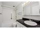 Clean bathroom with a bathtub, shower, and updated vanity at 3184 S Heather Gardens Way # 403, Aurora, CO 80014