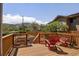 Wood back deck featuring beautiful mountain views, railing, and chairs at 420 Sunshine Pkwy, Golden, CO 80403