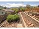 Landscaped backyard featuring rocks, terraced garden beds and a wooden fence at 420 Sunshine Pkwy, Golden, CO 80403