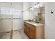 Bright bathroom with double vanity featuring granite counters, modern fixtures, and a tiled shower at 420 Sunshine Pkwy, Golden, CO 80403