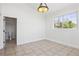 Bright bedroom with neutral tile flooring, recessed lighting, and an attached bathroom at 420 Sunshine Pkwy, Golden, CO 80403