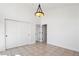 Bright bedroom with large closet, neutral tile floor, and classic light fixture at 420 Sunshine Pkwy, Golden, CO 80403