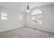 Spacious bedroom with neutral carpet, lots of natural light, and an arched window at 420 Sunshine Pkwy, Golden, CO 80403