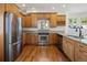 Kitchen featuring stainless steel appliances, granite countertops, hardwood cabinets and flooring at 420 Sunshine Pkwy, Golden, CO 80403