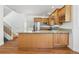 Kitchen features an island, wood cabinets, stainless steel appliances, and hardwood floors at 420 Sunshine Pkwy, Golden, CO 80403