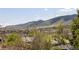 Scenic view of a city surrounded by lush, green mountains at 420 Sunshine Pkwy, Golden, CO 80403