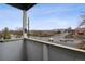 Balcony view of a street with local businesses, traffic, and a blue sky at 9120 E Girard Ave # 12, Denver, CO 80231