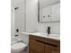 Modern bathroom features a wood vanity with black hardware, shower, and white tile at 9120 E Girard Ave # 12, Denver, CO 80231