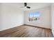 Bright bedroom with wood floors, a ceiling fan and a large window at 9120 E Girard Ave # 12, Denver, CO 80231