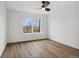 Bright bedroom features a ceiling fan, wood-look floors, and a large window for natural light at 9120 E Girard Ave # 12, Denver, CO 80231