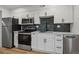 Modern kitchen with stainless steel appliances and white cabinets at 9120 E Girard Ave # 12, Denver, CO 80231