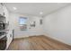 Modern kitchen with white cabinets and wood floors at 9120 E Girard Ave # 12, Denver, CO 80231