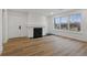 Bright living room with wood floors, fireplace, and large windows at 9120 E Girard Ave # 12, Denver, CO 80231