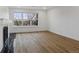 Bright living room with a fireplace and wood floors at 9120 E Girard Ave # 12, Denver, CO 80231