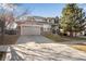 Traditional two-story home with a brick facade, attached garage, and landscaping at 6483 S Irvington Way, Aurora, CO 80016