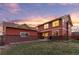 Scenic backyard with a lush lawn, garden beds, and an inviting patio for outdoor entertaining at 2414 Winding Dr, Longmont, CO 80504
