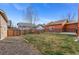Spacious backyard featuring a well-maintained lawn and a sturdy wooden fence offering privacy at 2414 Winding Dr, Longmont, CO 80504