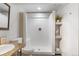 Bathroom featuring an updated vanity and toilet, and walk-in shower with seating at 2414 Winding Dr, Longmont, CO 80504