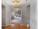 Open entryway leading to a carpeted living room with custom shelving at 2414 Winding Dr, Longmont, CO 80504