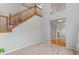 Spacious living room with a high ceiling, staircase and view to entryway at 2414 Winding Dr, Longmont, CO 80504