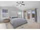 Comfortable bedroom with vaulted ceiling, natural light and access to an outdoor deck at 2414 Winding Dr, Longmont, CO 80504