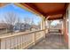 Relaxing front porch with a swing, decorative lighting, and a view of the neighborhood at 2414 Winding Dr, Longmont, CO 80504