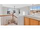 Bright landing area with staircase and lots of natural light provided by multiple windows at 2414 Winding Dr, Longmont, CO 80504