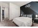 Comfortable bedroom with a unique design wall, complemented by a window and closet, offering a modern space at 25127 E Maple Ave, Aurora, CO 80018
